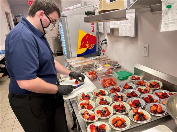 Student preparing fruit cups for culinary